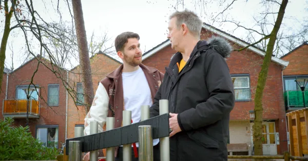 Woonbegeleider en bewoner lachen naar elkaar